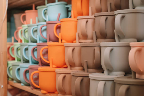 istock Multicolored silicone baby tableware stack with handles and forms on shelf of the store. Child healthcare, eco utensil 1391116157