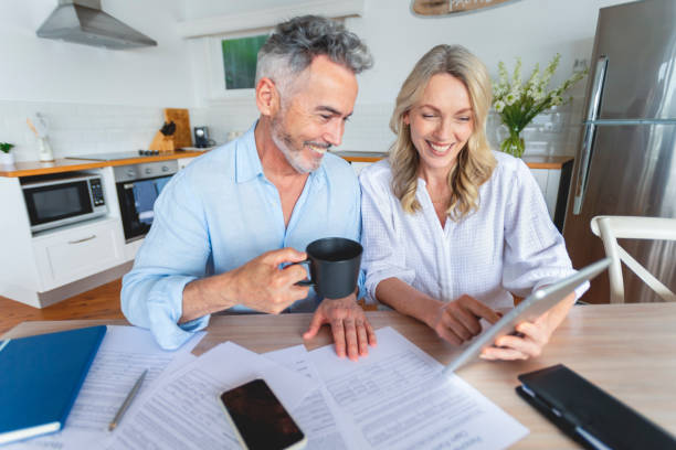 istock Mature couple doing paperwork and paying bills at home. 1391116261