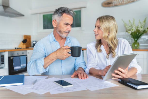 istock Mature couple doing paperwork and paying bills at home. 1391116262