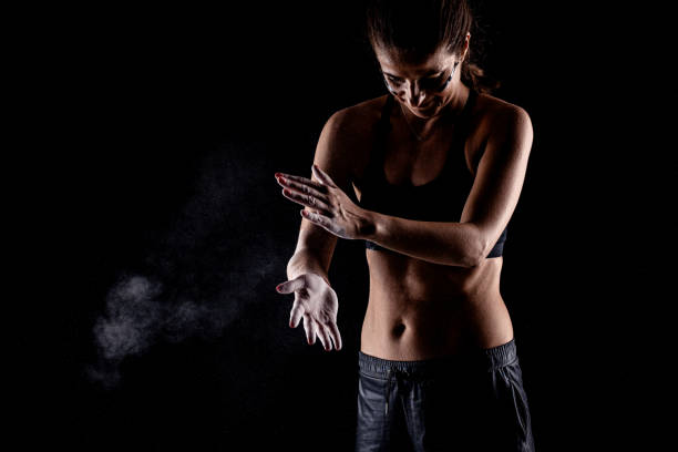istock Kickboxer kirl with magnesium powder on her hands punching with dust visible.. 1391120080
