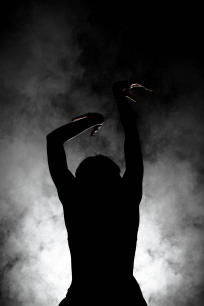 istock silhouette modern ballet dancer posing on dark background with smoke 1391120186