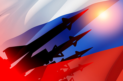 Silhouette of missiles on a background of the flag of Russia and the sun. Nuclear weapon concept.