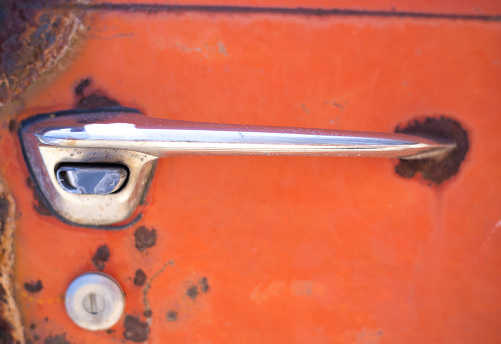 Weathered Rusty Old Car Door in Orange, Close-Up