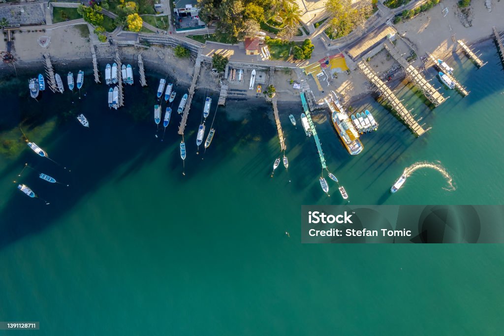 Aerial of boats in a port in lake Atitlan Guatemala Aerial of boats in water in lake Atitlan Gutemala during sunrise Guatemala Stock Photo