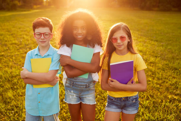 istock Diverse kids with textbooks in park 1391129728