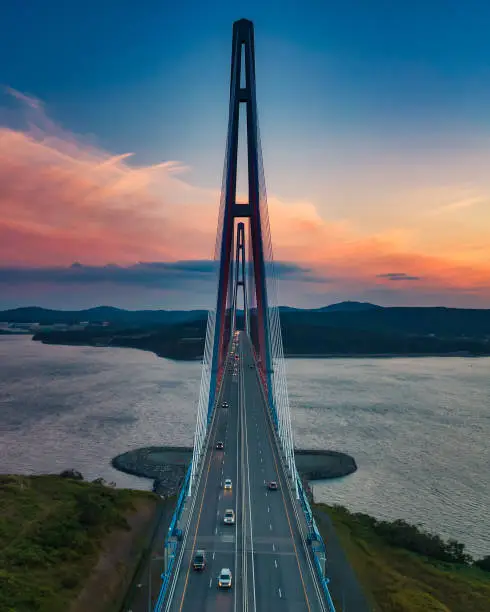 Sunset aerial view of famous cable-stayed bridge to Russky island from Vladivostok city in Far East of Russia
