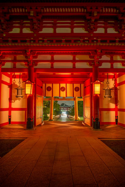 Fushimi Inari a historical Japanese shrine in Kyoto Japan.  A serene zen walk down a stone path past the many red Shinto torii gate in the morning and evening.  The mood is alway tranquil weather lit by the sun beams at dawn or shadowy corners created by the lanterns at night.