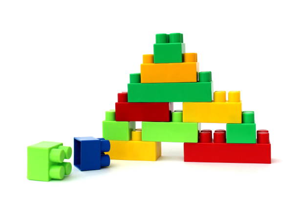 Bright multi-colored cubes of the designer scattered lie on a white isolated background.