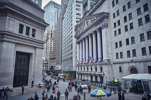 New York City - April 02 2015 : People outside of The New York Stock Market and Exchange building at the Manhattan Financial District