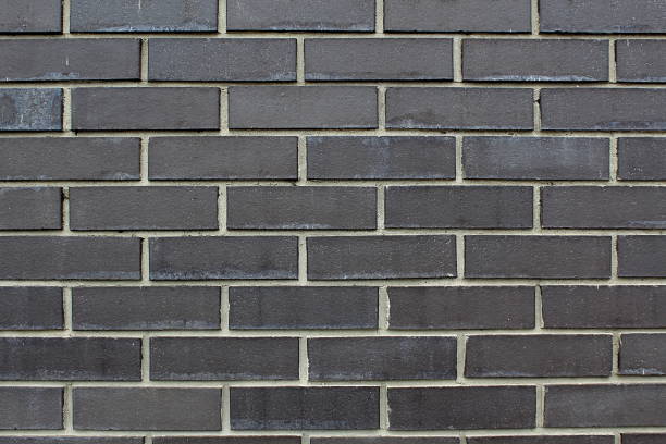 istock Texture of dark gray brick wall. 1391147155