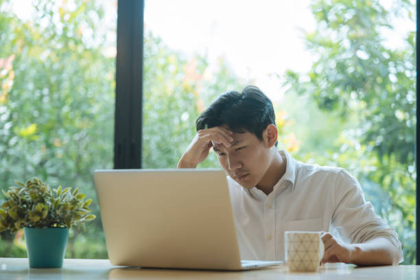 istock Young Asian man having stressful time working on laptop 1391147986