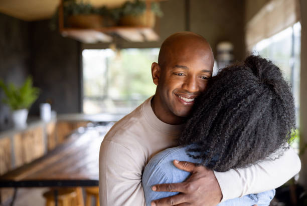 istock Loving man hugging his wife at home 1391148899
