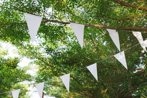 istock white triangle flags are hanging on tree branches. concept : decoration for party. 1391150405