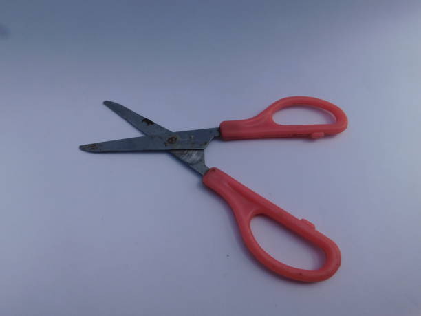 istock pink scissors isolated on a white background 1391153126