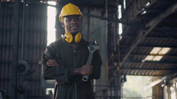 istock Engineer standing holding wrench tools and arms crossed at work in the industry 1391153969