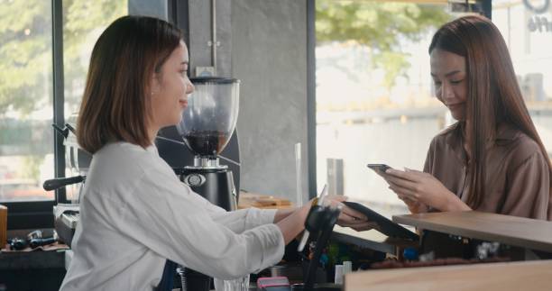 istock customer woman using digital smartphone application scanning QR code payment without money for buying coffee 1391153999