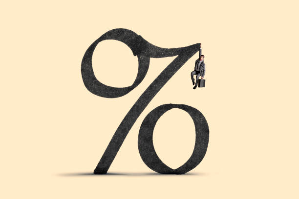 istock Man Hanging On As Interest Rates Climb 1391157740