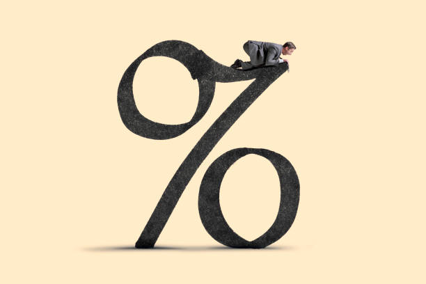 istock Man Looking Over Edge Large Interest Rate Sign 1391157743