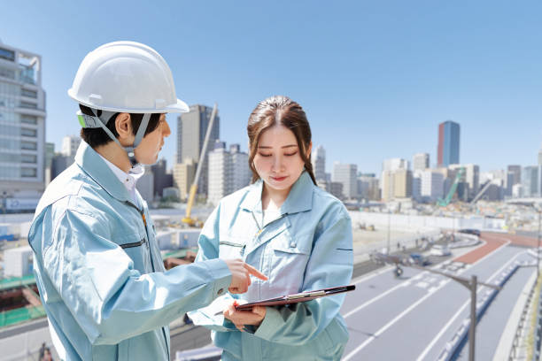 Asian workers having a meeting at the construction site