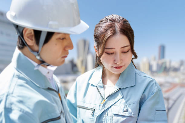 istock Asian workers having a meeting at the construction site 1391158710