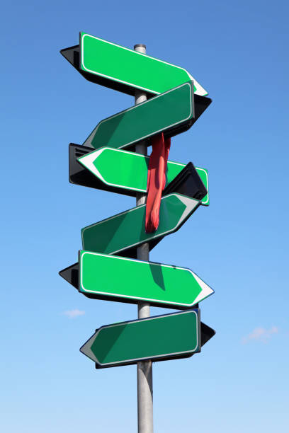 istock Blank green road sign against blue sky and clouds. 1391159510