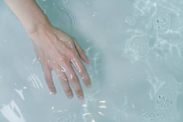 istock Close up woman hand in bathtub 1391159607