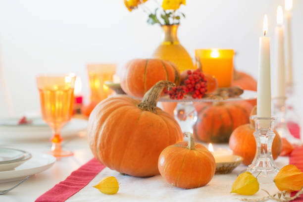 istock autumn table setting with burning candles and pumpkins 1391160704