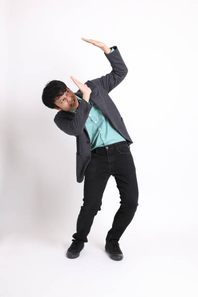 Young Asian Businessman The young adult businessman standing on the white background. asian suit man cross hand stock pictures, royalty-free photos & images