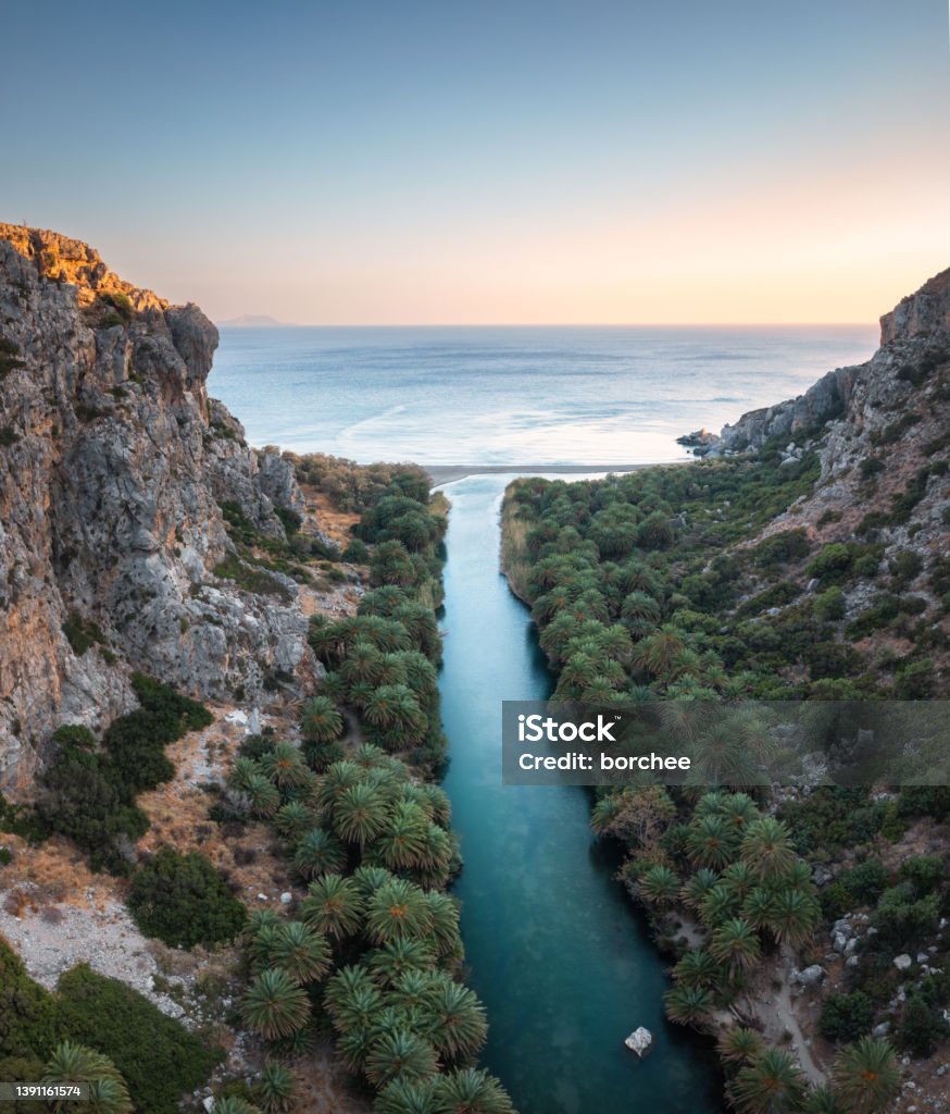 Preveli Gorge In Crete Famous Preveli gorge with river and palm tree forest (South Chania, Crete, Greece). Aerial view at sunset. Crete Stock Photo