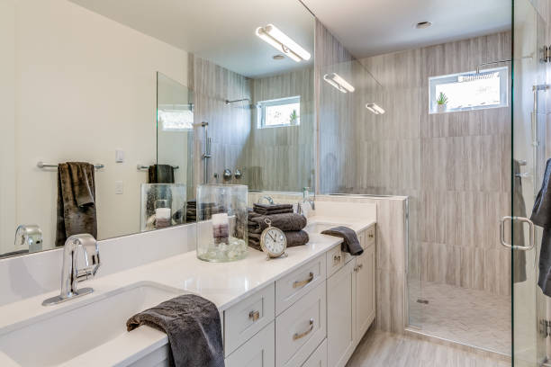 istock Bathroom with double vanities and large mirror wall 1391162497
