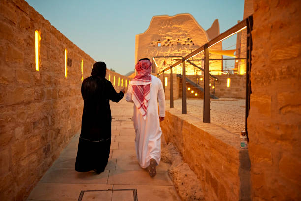 Saudi tourists exploring Diriyah ruins at dusk