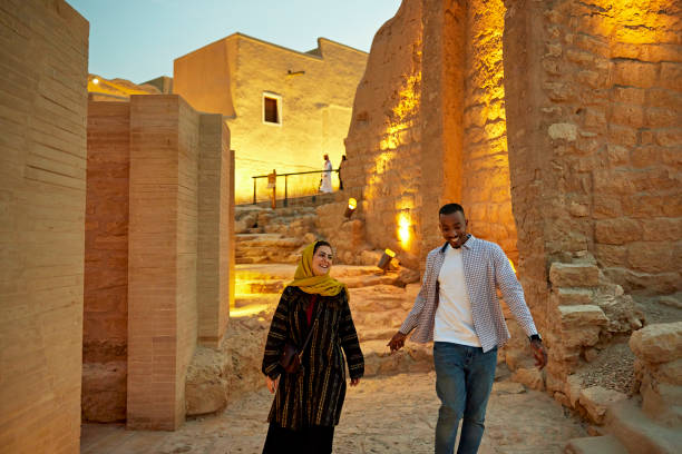 istock Smiling tourists walking through open air museum near Riyadh 1391163272