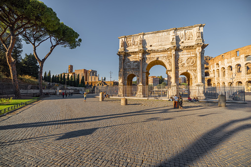 View on Arch of Constantine near Colosseum in Rome. Traveling Italian landmarks concept. Idea of tourist places and attractions