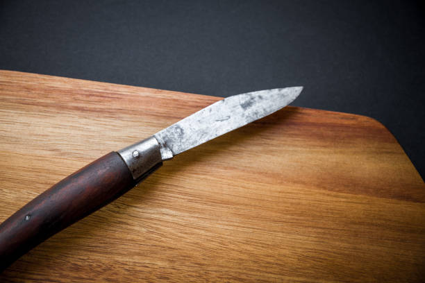 istock Traditional pocket knife on a wooden cutting board 1391165421