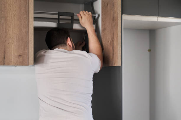 istock Young latin man installing an accessible kitchen cabinet in the kitchen. 1391166630