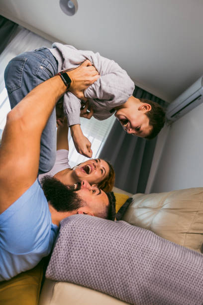 istock Young family with their son at home having fun 1391167816