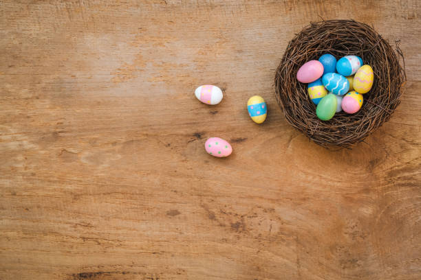 istock Colorful Easter Egg and nest on a rustic old wood background. Above view with copy space. 1391167889