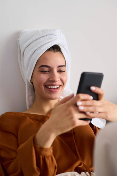 istock Young laughing female looking at smartphone screen while messaging 1391168935