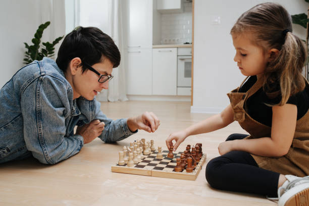 istock Yound dad playing chess on the floor with his child daughter 1391169622