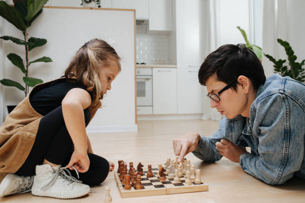 istock Competitive chess match between dad and his child daughter. Both having fun 1391169626