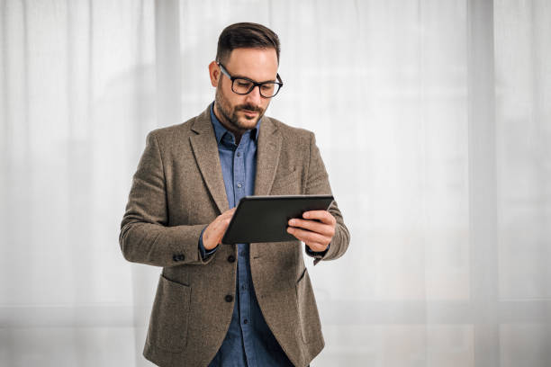 istock Serious businessman making plan on digital tablet at corporate office 1391170324