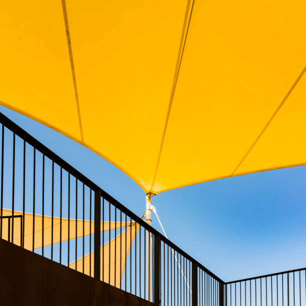 White sky is golden yellow from sunlight, blue sky, railings