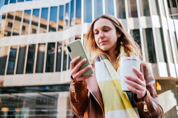 istock Woman with coffee browsing smartphone 1391172748
