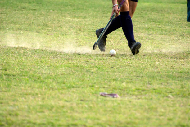 Hockey player going to pick up hockey ball. Photo is captured with panning