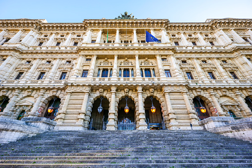 Rome, Italy, February 10 -- The imposing Palazzo di Giustizia (Justice Palace) in the Prati district, in the historic center of Rome. Built in the Umbertine style between 1889 and 1911 by the architect Guglielmo Calderini, it is the seat of the Corte Suprema di Cassazione (Supreme Court of Cassation of Italy), the highest court of appeal or court of last resort in Italy. Legal appeals to the Italian Supreme Court of Cassation generally come from the Court of Appeal, from the second instance courts, but also from the accused or from the prosecutors from the first instance courts. Super wide angle image in High Definition.
