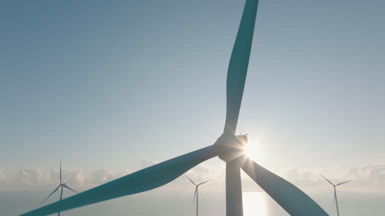 Sunset or morning of Aerial view of the wind turbines in the sea, Renewable energy, Clean renewable green wind power.Classic energy concept.