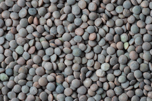 istock Brown lentils as background. Top view 1391181214