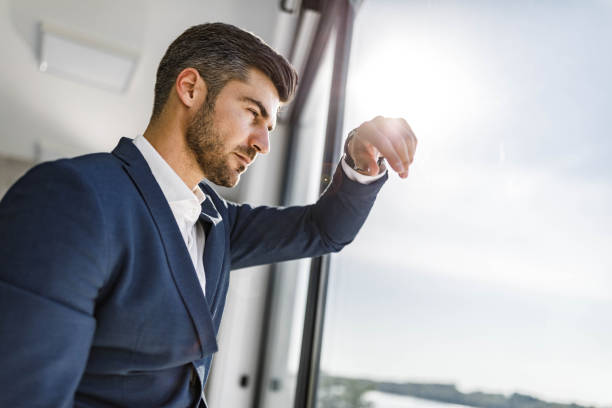 istock Worried businessman looking through window. 1391181311