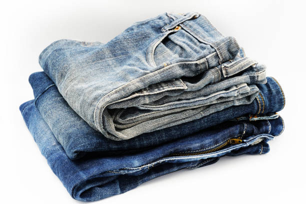 istock Blue jeans isolated on white background, jeans stacked 1391182449