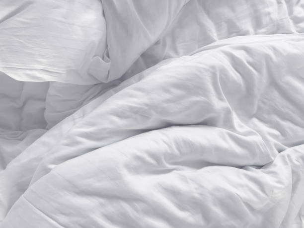 istock Messy white bed duvet cover 1391183519